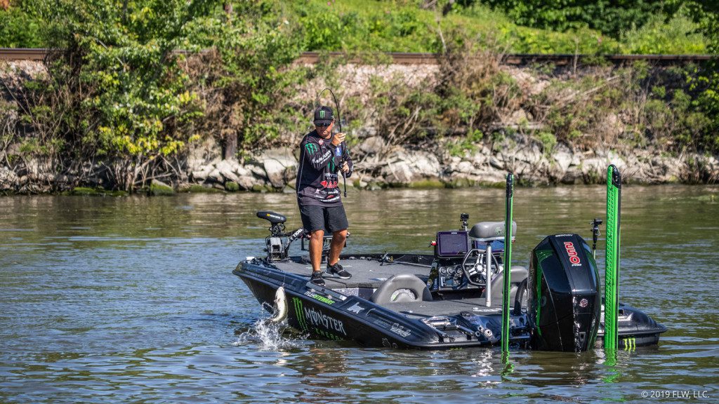 FLW-Tour-pro-Tyler-Stewart-hoists-a-largemouth-into-his-boat-on-Day-Two-of-the-FLW-Tour-on-Lake-Champlain-presented-by-T-H-Marine.-Curtis-Niedermier